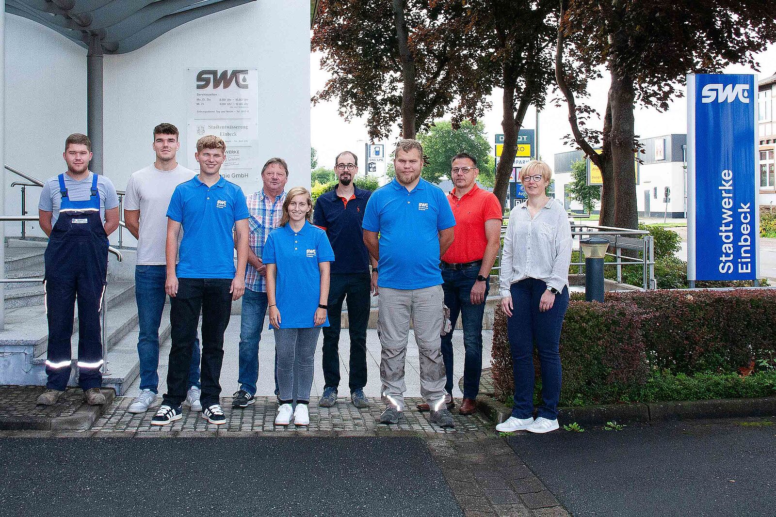 Foto von den vier neuen Auszubildenden, den Gesellen und den Ausbildern vor dem Eingang der Stadtwerke Einbeck GmbH